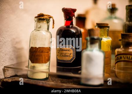 old medicine bottles behind the ancient display case bottles with ancient brown writings in Cuzco Inca city on the Peruvian highlands Stock Photo