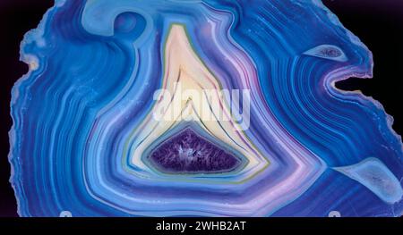 Backlit thin slice of blue Agate with crystals in a geode, lit from behind Stock Photo