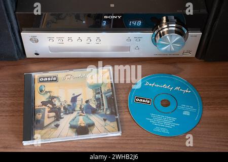 Definitely Maybe was originally released in August 1994 by Oasis. It was the fastest selling debut album ever (at the time). CD jewel case and CD Stock Photo