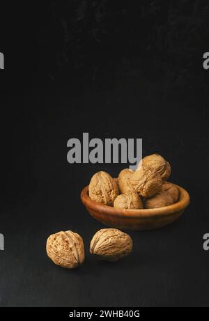 Walnuts on a dark background. The concept of proper nutrition. Walnuts are an excellent source of antioxidants and including LDL cholesterol, which pr Stock Photo