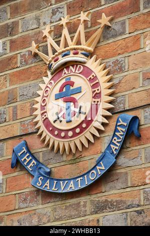 The crest of the Salvation Army, a Protestant Christian movement, with the motto “Blood and Fire”, mounted on the wall of the Wimborne Church. Dorset. Stock Photo