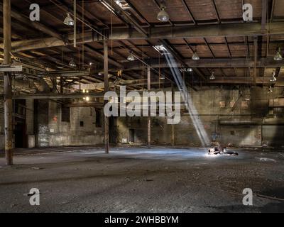 Homeless man sleeping in abandoned warehouse, Philadelphia, USA Stock Photo