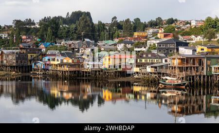 Colorful stilt houses,so-called palafitos, of the capital of Castro on the island of Chiloe in Chile. Stock Photo
