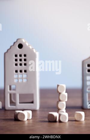 Blank wooden blocks with miniature houses in the background. Mortgage and Personal Finance Concept. Vertical Orientation Stock Photo