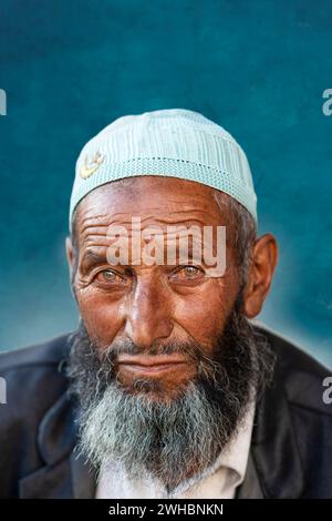 A portrait of an elderly Muslim Ladakhi men wearing a skullcap also known as Taqiyah. Stock Photo