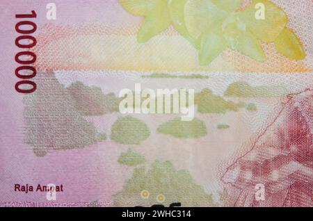 One hundred thousand rupiah banknote flying on a white background. Uang ...