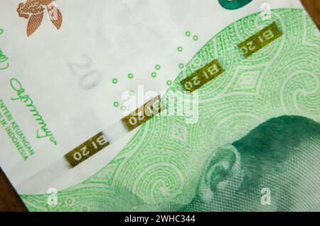 Macro photography of IDR 20,000 banknotes. Close-up of an Indonesian twenty thousand rupiah banknote with security thread. Rupiah is the official curr Stock Photo