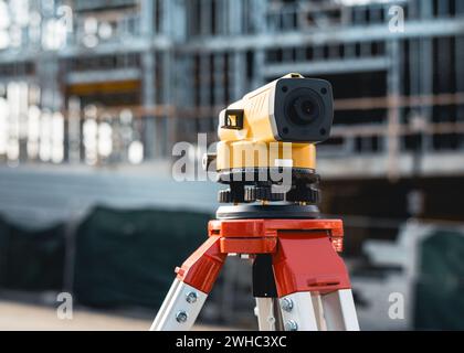 Builders automatic level on a tripod at the work jobsite Stock Photo