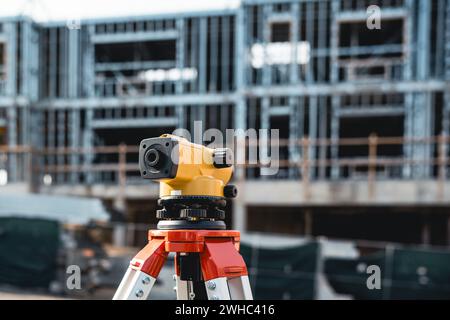 Construction auto level on a tripod at the work jobsite Stock Photo