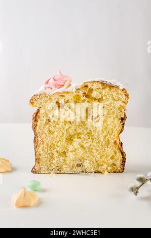 Place setting for Easter dinner on the white table with Easter cake with colorful topping, Decorative chocolate eggs sweets, willow and holiday decora Stock Photo
