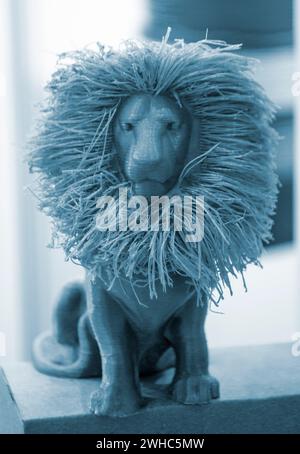 Art object model of lion printed on 3D printer. Lion toy created by 3D printing from molten plastic. Example of creating prototype by 3D printer. Concept 3D printing. Printing innovation technology Stock Photo