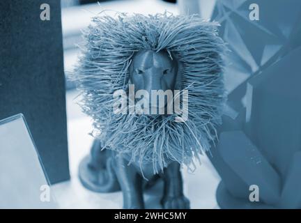 Art object model of lion printed on 3D printer. Lion toy created by 3D printing from molten plastic. Example of creating prototype by 3D printer. Concept 3D printing. Printing innovation technology Stock Photo