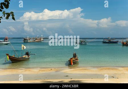 Longtail boats at the Haad Salad Beach on the thai island Koh Phangan in the gulf of Bangkok Stock Photo