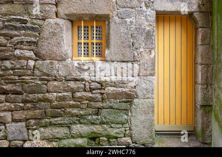 House facade with yellow door and yellow windows, Roscoff, Finistere, Brittany, France Stock Photo