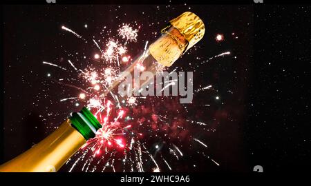 Champagne bottle before fireworks on New Year's Eve Stock Photo