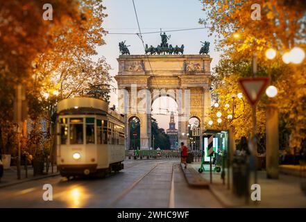 View of the Peace Arch with yellow tram in Milan, Italy Stock Photo