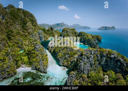 Aerial drone view of turquoise big and small lagoons surrounded by steep rocks, Marine National Reserve in El Nido, Palawan. Stock Photo