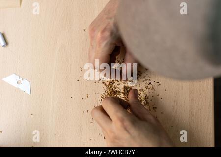 Top view of an unrecognizable man preparing rolling cigarette Stock Photo