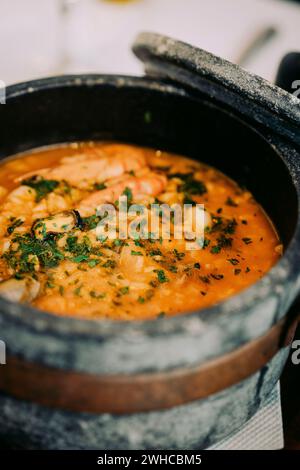 National cuisine of Cape Verde: Cachupa in traditional stone bowl. Close-up Stock Photo