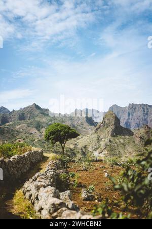 Hiking trail leading through arid rocky terrain towards Coculli village on Santo Antao Cape Verde. Stock Photo