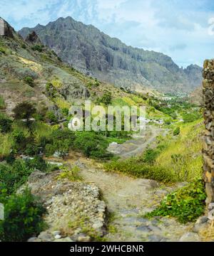 Palm trees in front of arid rocky terrain. Huge barren mountain in background. Santo Antao Island, Cape Verde. Stock Photo