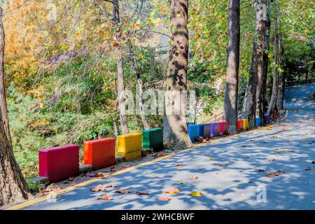 Colorful concrete blocks lining side of paved road in mountain park Stock Photo