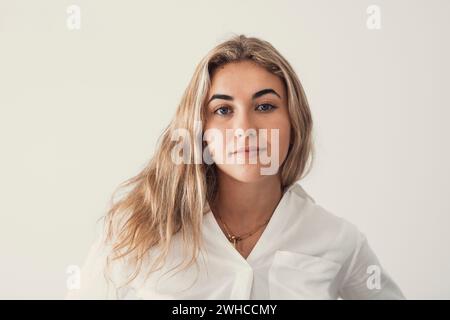 Close up overjoyed woman laughing, sitting on couch at home, head shot portrait young female chatting online with friends or relatives, looking at camera, having fun, making call or shooting video Stock Photo