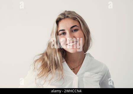 Close up overjoyed woman laughing, sitting on couch at home, head shot portrait young female chatting online with friends or relatives, looking at camera, having fun, making call or shooting video Stock Photo