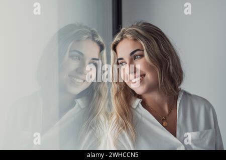 Portrait, close up of dreamy smiling woman looking in distance thinking, visualizing good future, excited happy beautiful young female businesswoman dreaming of new opportunities, planning Stock Photo