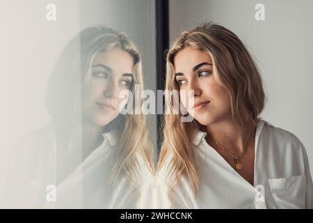 Portrait, close up of dreamy smiling woman looking in distance thinking, visualizing good future, excited happy beautiful young female businesswoman dreaming of new opportunities, planning Stock Photo