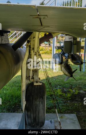 Rear view of landing gear and battery of missiles mounted under wing of military jet aircraft on display in public park Stock Photo