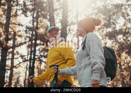 Portrait close up head shot of one cheerful smiling middle age woman walking with her husband enjoying free time and nature. Active beautiful seniors in love together at sunny day. Stock Photo