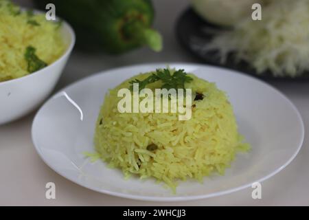 Spiced papaya rice. A quick stir fried rice recipe with green papaya, turmeric and a tadka of spices and nuts to make a one pot meal. Ideal for topics Stock Photo