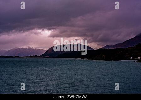 A photo of the Alaskan coastline with dark ominous clouds overhead Stock Photo