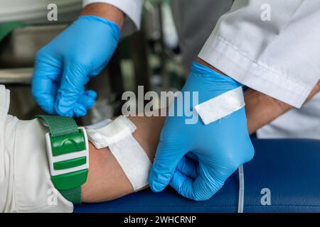 A Person In Gloves Putting A Needle On A Mannequin. Stock Photo