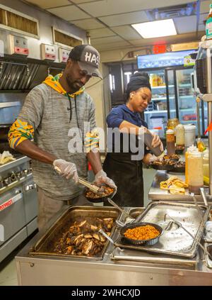 Detroit, Michigan - Workers prepare food at Yum Village restaurant, which serves Afro-Caribbean meals. Stock Photo
