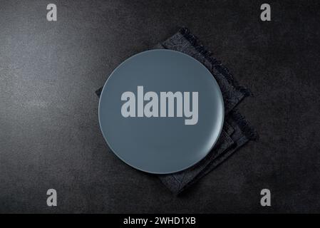 Top view of grey empty plate on dark grey background Stock Photo