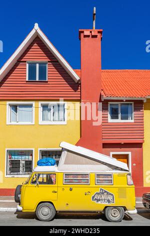 Yellow Volkswagen van in retro style in front of a yellow and red house, Ushuaia, Tierra del Fuego Island, Patagonia, Argentina Stock Photo