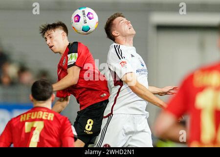 Wiesbaden, Germany. 09th Feb, 2024. Soccer: Bundesliga 2, SV Wehen Wiesbaden - 1. FC Nürnberg, Matchday 21, BRITA-Arena. Wiesbaden's Nick Bätzner (l) and Nuremberg's Florian Flick fight for the ball. Credit: Uwe Anspach/dpa - IMPORTANT NOTE: In accordance with the regulations of the DFL German Football League and the DFB German Football Association, it is prohibited to utilize or have utilized photographs taken in the stadium and/or of the match in the form of sequential images and/or video-like photo series./dpa/Alamy Live News Stock Photo