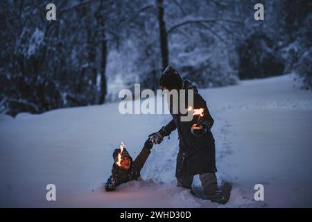 Family torchlight hike in the forest Stock Photo