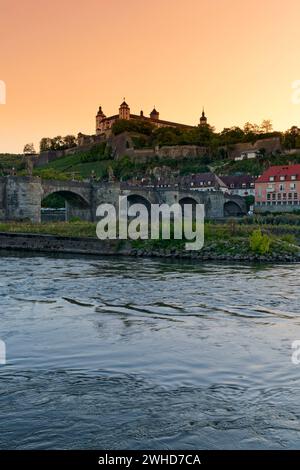 View from the Main promenade to the Old Main Bridge and the Marienberg Fortress in Würzburg at sunset, Lower Franconia, Franconia, Bavaria, Germany Stock Photo