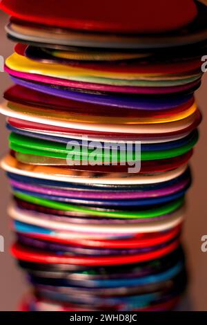 Multicoloured Pile Stacked of Guitar Plectrums and Picks Against Beige Background Collage Design Abstract Colours Stock Photo