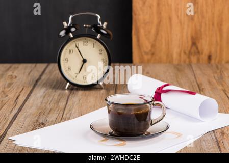 Old clock, hat, coffee and paper sheets Stock Photo