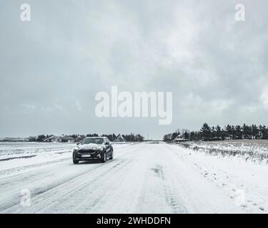 Car on a snow-covered country road Stock Photo