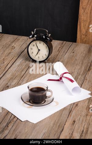 Old clock, hat, coffee and paper sheets Stock Photo
