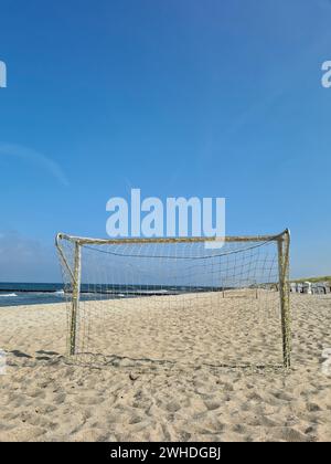 View of the sea on the horizon through the soccer goal on the beach in Markgrafenheide, Baltic Sea, Germany Stock Photo