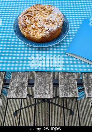 Apple pie with crumble on a blue plate for dessert Stock Photo