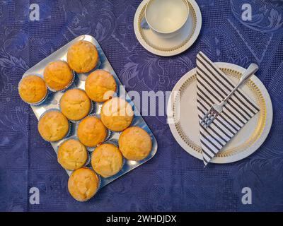 Cake service and silver tray with muffin on a blue festive tablecloth Stock Photo