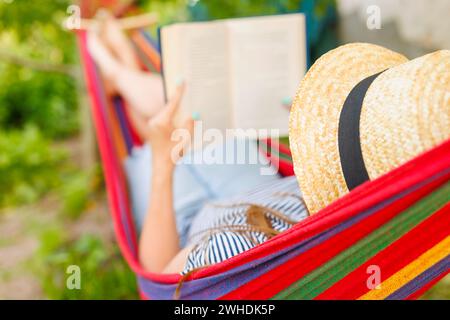 Relaxing Summer Reading in a Hammock Stock Photo