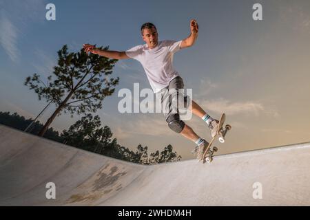 Skateboarder in a concrete pool Stock Photo